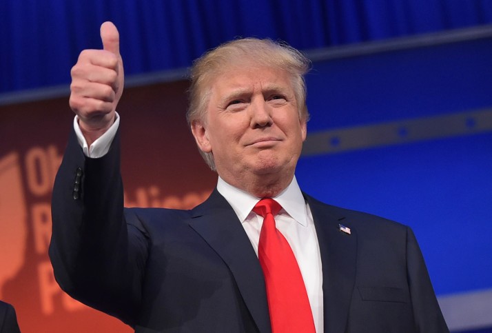Real estate tycoon Donald Trump flashes the thumbs-up as he arrives on stage for the start of the prime time Republican presidential debate on August 6, 2015 at the Quicken Loans Arena in Cleveland, Ohio. AFP PHOTO/MANDEL NGAN        (Photo credit should read MANDEL NGAN/AFP/Getty Images)