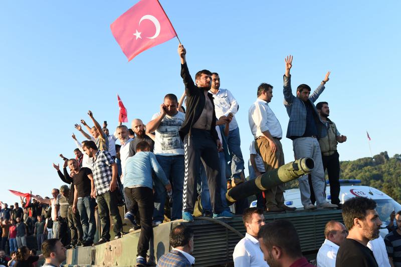 EDITORS NOTE: Graphic content / People react after they take over military position on the Bosphorus bridge in Istanbul on July 16, 2016. 
At least 60 people have been killed and 336 detained in a night of violence across Turkey sparked when elements in the military staged an attempted coup, a senior Turkish official said. The majority of those killed were civilians and most of those detained are soldiers, said the official, without giving further details.

 / AFP PHOTO / Bulent KILICBULENT KILIC/AFP/Getty Images