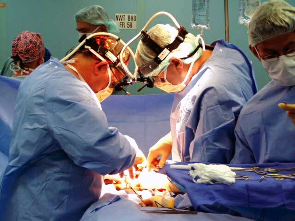 030223-N-8119R-001 At sea in the Indian Ocean (Feb. 23, 2003) -- Navy doctors, Cmdr. Donald Bennett (left), and Cmdr. Ralph Jones (right), perform surgery on a civilian crewmember in one of the operating rooms aboard the Military Sealift Command (MSC) hospital ship USNS Comfort (T-AH 20). Comfort is deployed in support of Operation Enduring Freedom. U.S. Navy photo by Lt. Cmdr. Roy Rice. (RELEASED)